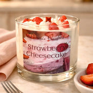 Strawberry Cheesecake Candle in a glass jar with strawberries and whipped cream on top, perfect for cozy atmospheres.