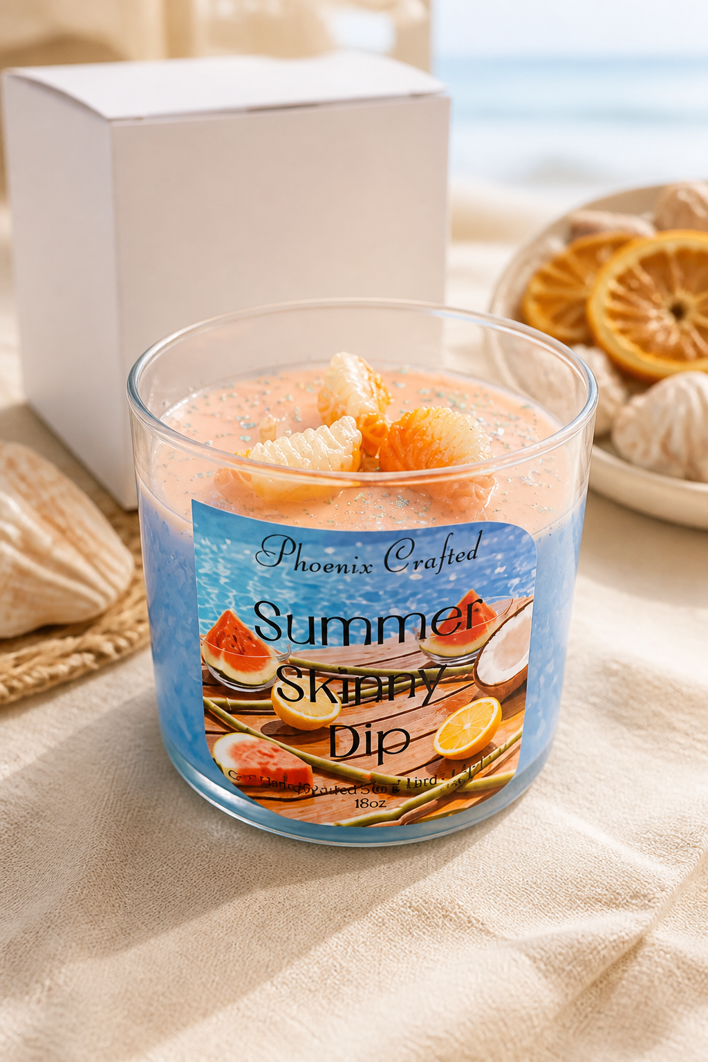 Image of Summer Skinny Dip Candle with tropical fruits, set against a beach background.