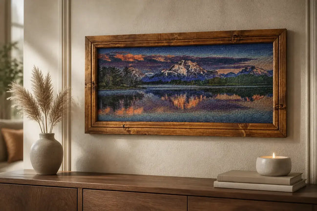 Sunset over Still Waters Diamond Painting displayed in a wooden frame above a console table with decor.
