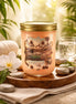 Peach-pink candle in a clear glass mason jar with gold screw lid labeled "Tranquil Oasis".