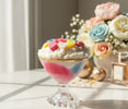 Tropical Sorbet Decorative Candles with colorful toppings in a glass, surrounded by flowers and soft lighting.