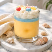 Tropical Sorbet Decorative Candles in a colorful dessert-style candle with whipped topping and decorative candies.
