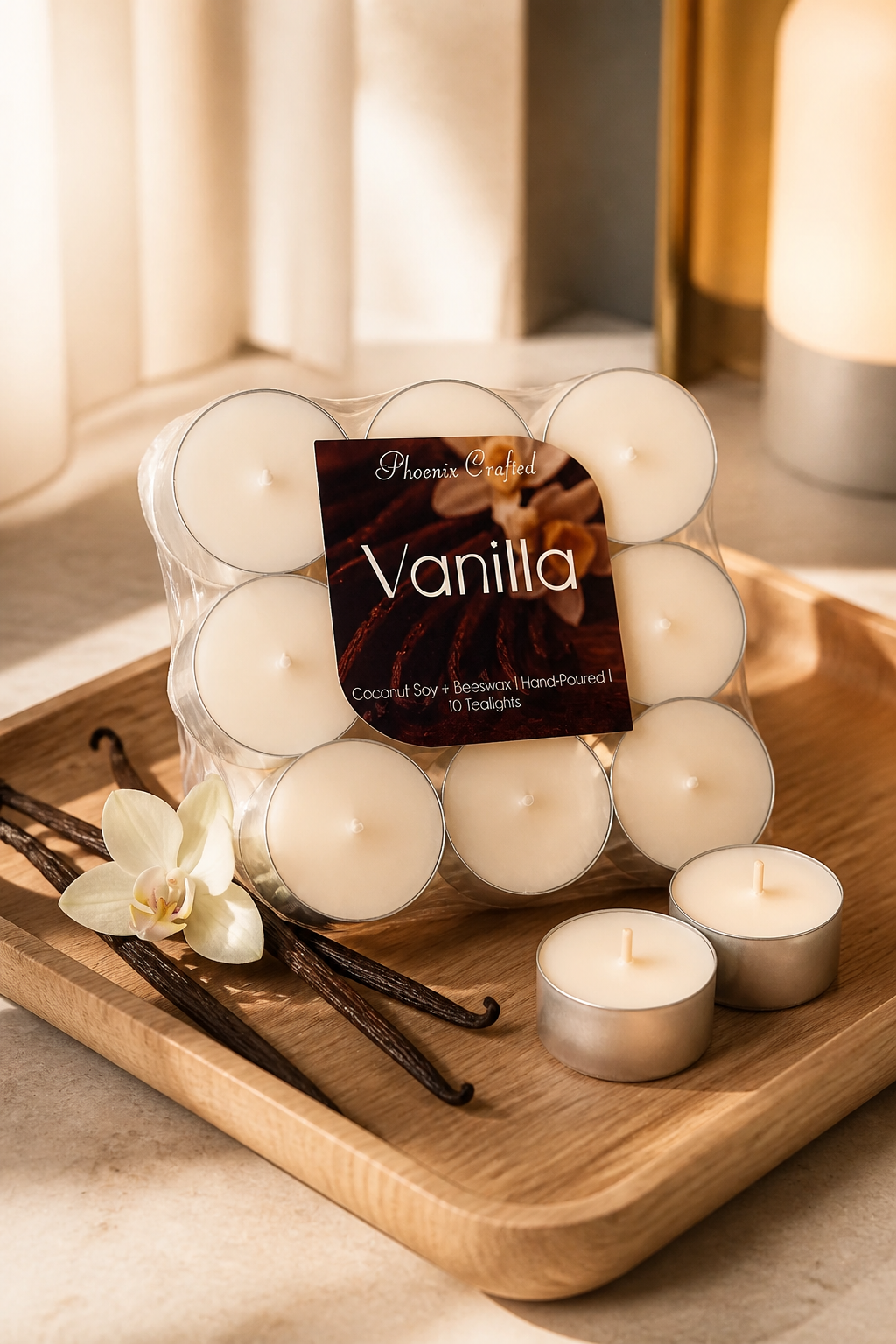 Vanilla Tealights in a pack with vanilla pods and a flower on a wooden tray, showcasing cozy candlelight.
