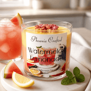 A Watermelon Lemonade Candle on a table with fresh watermelon, lemon slices, and a drink in the background.
