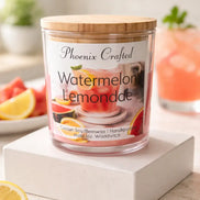 Watermelon Lemonade Candle in a clear jar with a wooden lid, surrounded by fresh lemons and watermelon.