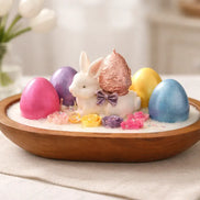 Watermelon Lemonade Candle Easter decoration featuring a white bunny and colorful eggs in a wooden bowl with flowers.