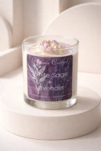 White Sage & Lavender Candle in a glass jar on a pedestal with decorative label and lavender top.