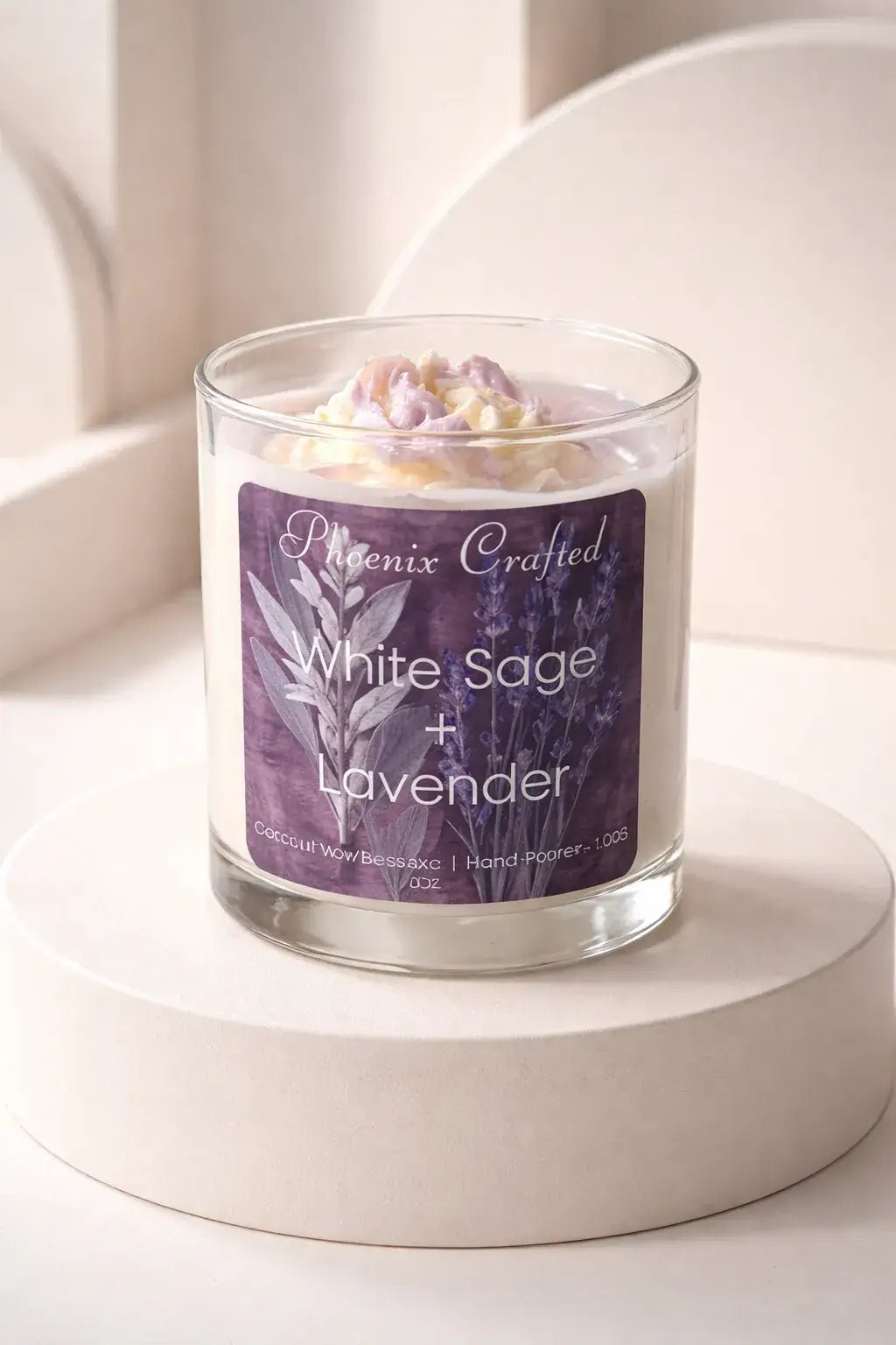White Sage & Lavender Candle in a glass jar on a pedestal with decorative label and lavender top.