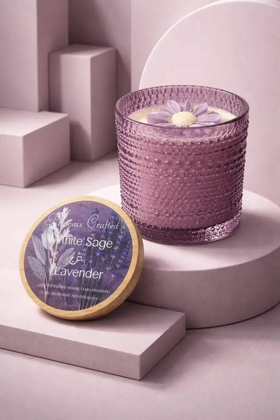 Lavender-hued textured glass candle with cream wax and a purple flower topper.