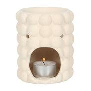 Cream speckle bubble tealight wax warmer with a trendy bubble design and a candle inside.