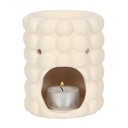 Cream speckle bubble tealight wax warmer with a trendy bubble design and a candle inside.