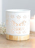 Matte ceramic butterfly oil burner with cut-out design illuminating a tealight candle.