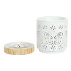 Matte ceramic butterfly oil burner with tealight holder featuring intricate butterfly cut-out design.