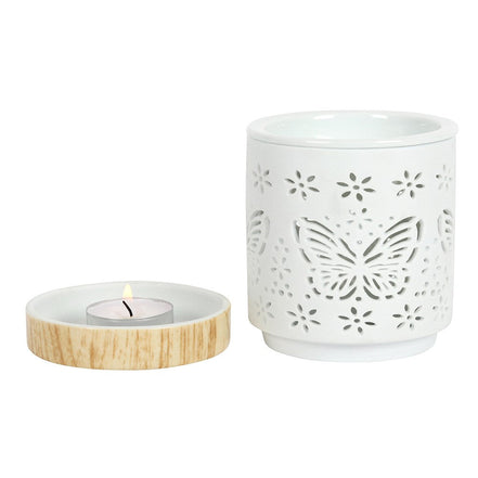 Matte ceramic butterfly oil burner with tealight holder featuring intricate butterfly cut-out design.