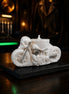 Pearl-white sculpted motorcycle candle with skull rider and hand-painted silver accents on slate base — Cedarwood Rider by Phoenix Crafted