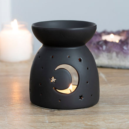 Black moon cut out oil burner with crescent moon and star design, ideal for Halloween and spooky decor.