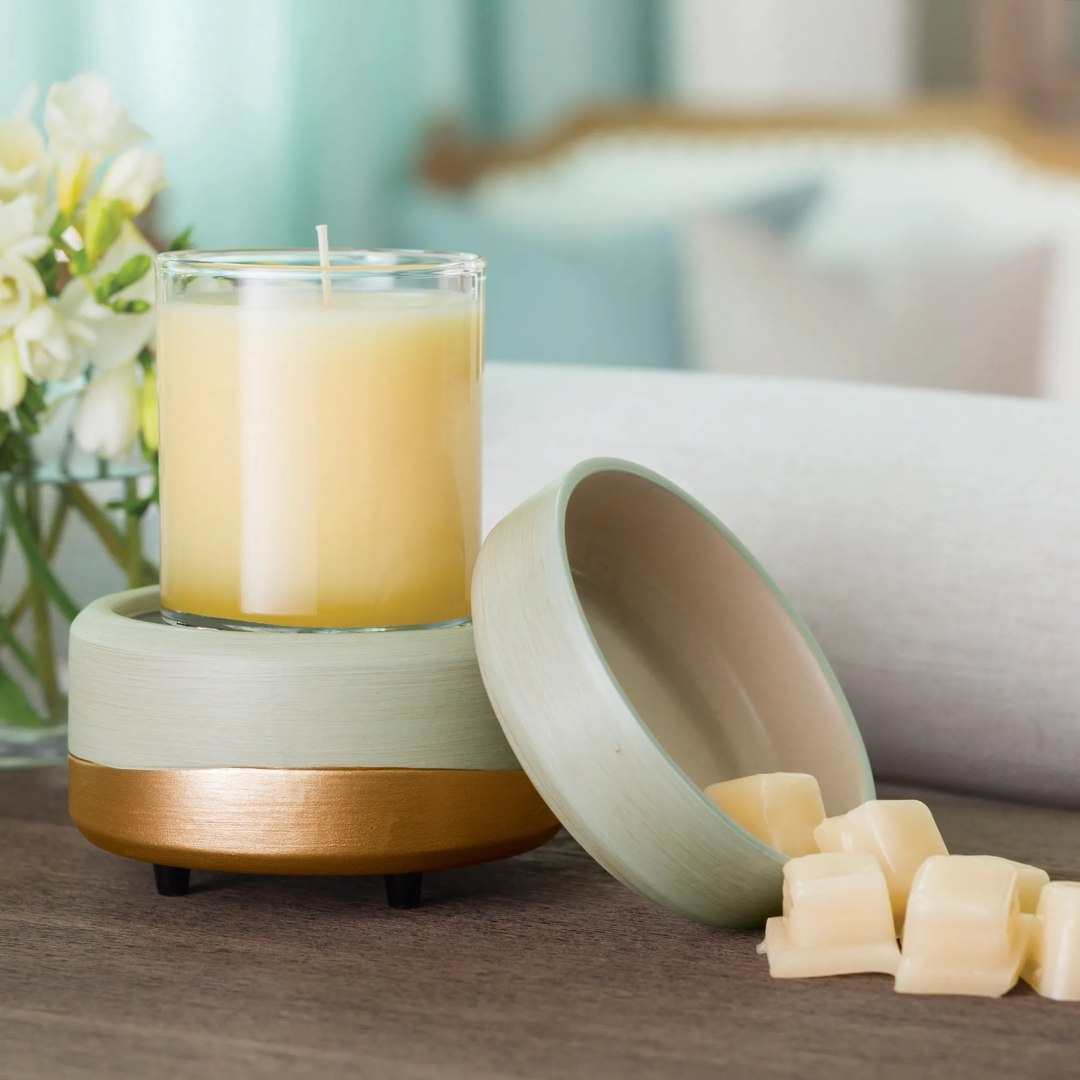 Earth-tone candle and wax melt warmer displaying a jar candle and wax melts on a wooden surface.