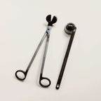 Brass candle snuffer tool and wick trimmer set for candle care and maintenance.