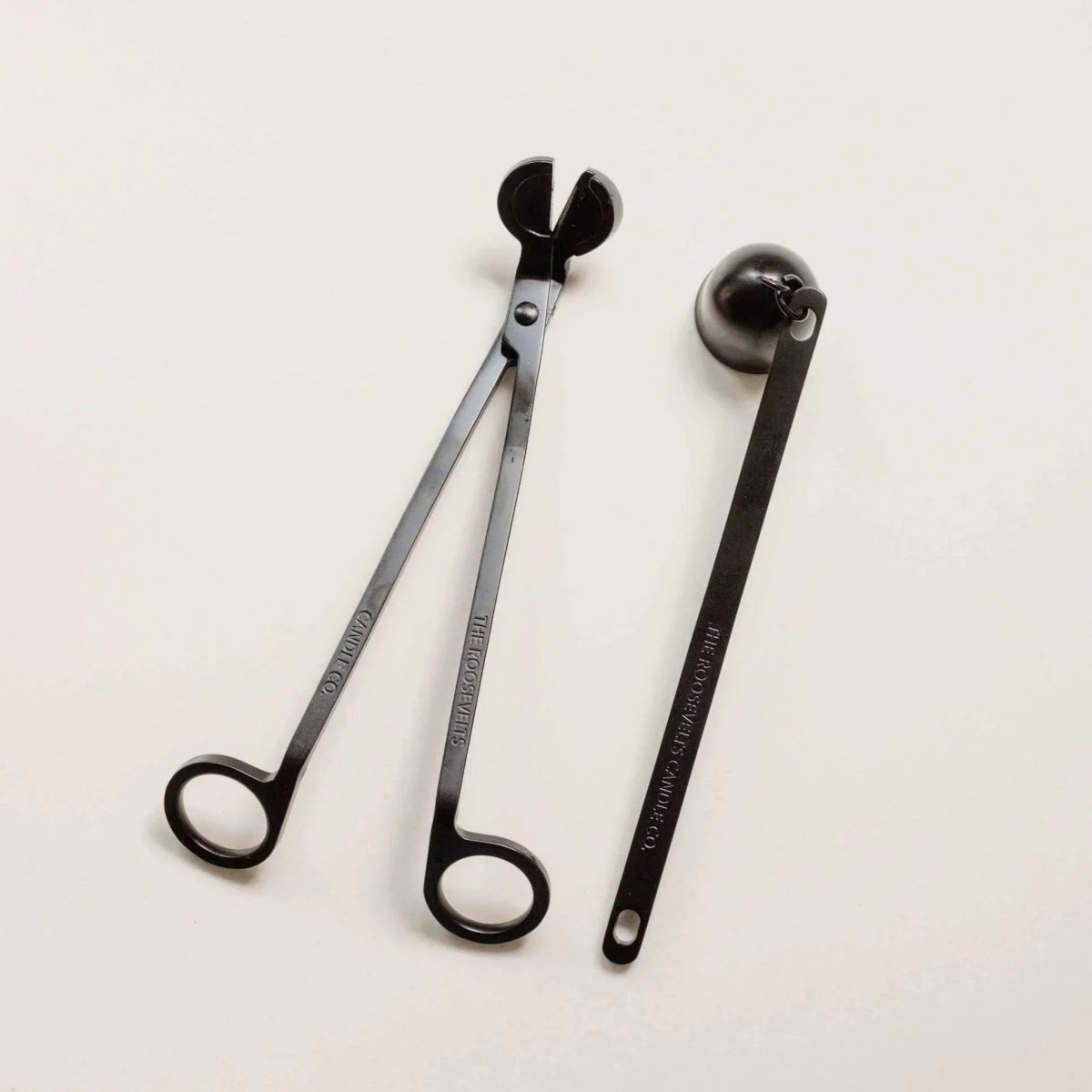 Brass candle snuffer tool and wick trimmer set for candle care and maintenance.
