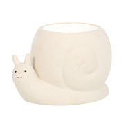 Beige speckled snail-shaped wax warmer with open-top round bowl shell, white interior, smiling face and black dot eyes on a white studio background