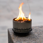 Close view of the wrought-iron trivet and candle holder construction.