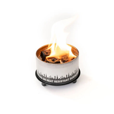 Matte-black trivet and candle holder shown from an alternate angle.