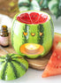 Glossy green ceramic watermelon warmer with red seeded basin and three heart-shaped cutouts lit by a tealight; matching lid.