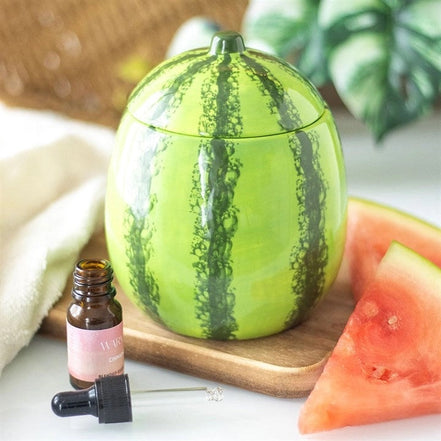 Round green ceramic watermelon-shaped wax warmer with lid and dark vertical stripes.